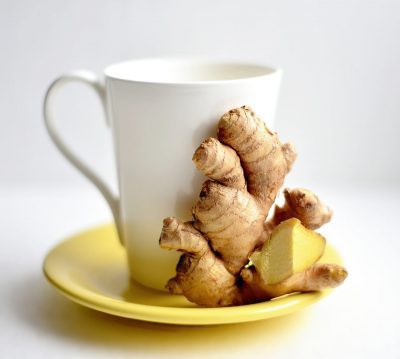 ginger kept in a yellow tea plate with a white tea mug