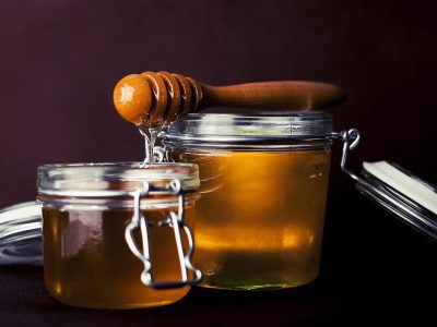 two jars of honey in a transparent container