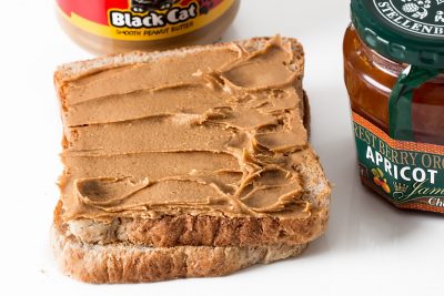 peanut butter has been spread on a slice of bread