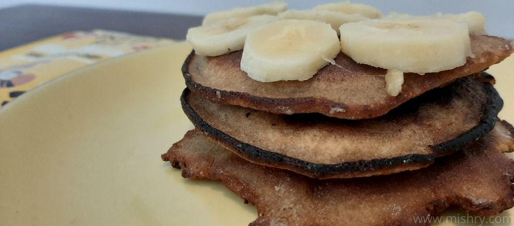banana choco-chip pancakes topped with banana and honey