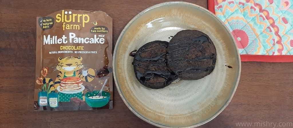 slurrp millet chocolate pancake garnished with chocolate sauce