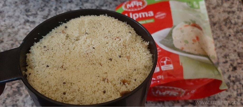 upma instant mix powder in a black pot
