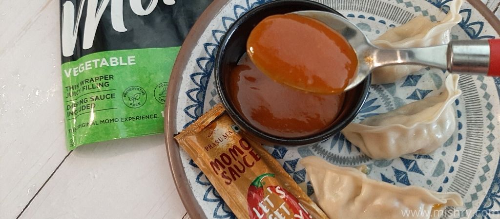 closer look at prasuma momos sauce in a spoon