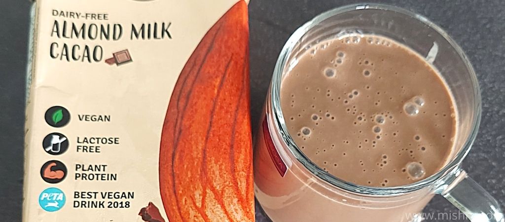 closer look at raw pressery almond milk cacao in a glass