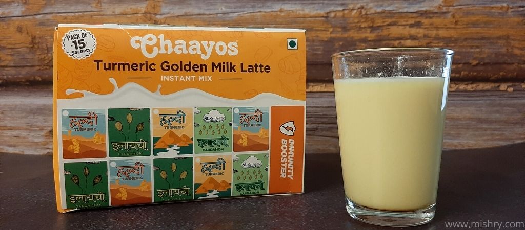 chaayos turmeric golden milk in a glass after mixing in hot water