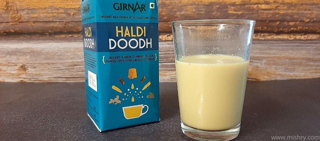 girnar haldi doodh in a glass after mixing in hot water