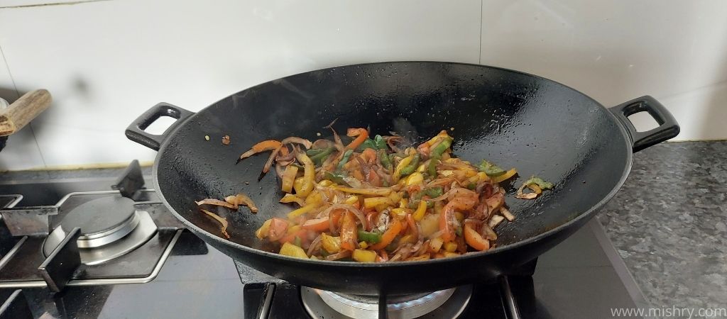 veggies frying on iron wok pan