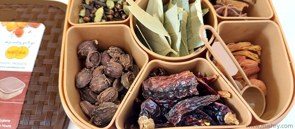 closer look at spices inside nakoda titan plastic masala box