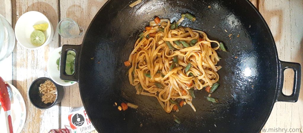 extra hot thai chilli pad thai noodles frying on pan
