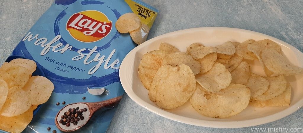 lays wafer style salt with pepper potato chips on a plate